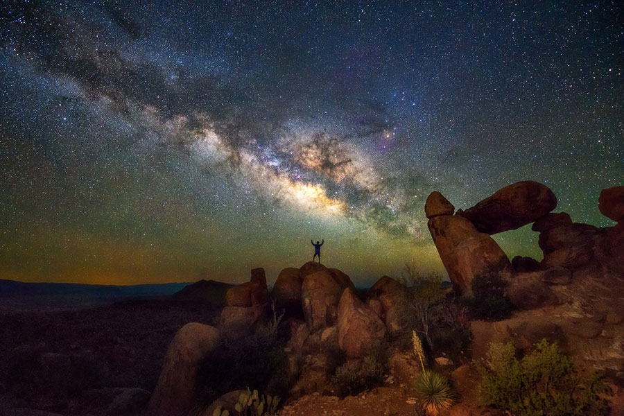 person on top of rock at Big Bend National Park at night